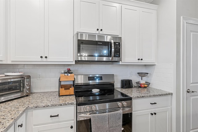 3008 Locust Blossom Cv, Lexington, KY 40511 - kitchen with stainless steel appliances, backsplash, white cabinetry, and light stone countertops