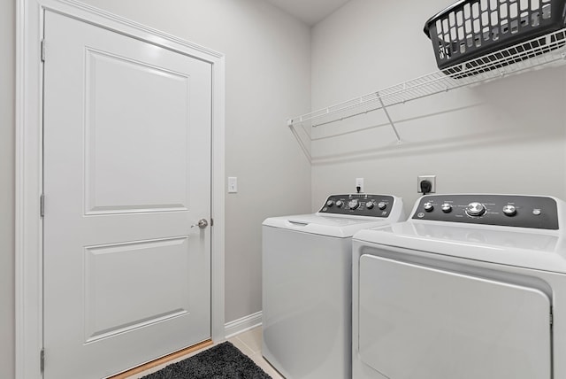 3008 Locust Blossom Cv, Lexington, KY 40511 - laundry room with washing machine and clothes dryer, light tile patterned flooring, and baseboards