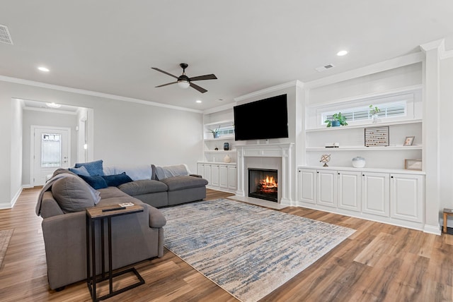 3008 Locust Blossom Cv, Lexington, KY 40511 - living room with a fireplace with flush hearth, ceiling fan, light wood-style flooring, ornamental molding, and recessed lighting