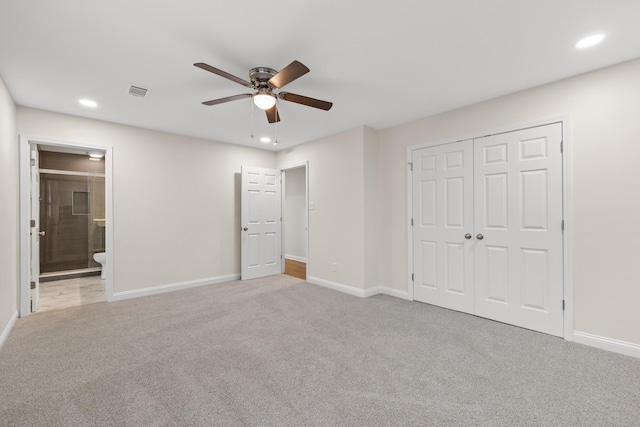 unfurnished bedroom featuring carpet floors, baseboards, recessed lighting, a closet, and ensuite bath