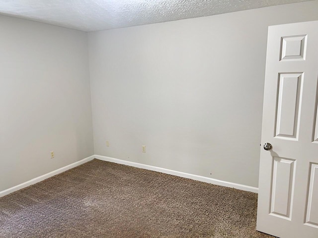 1204 Red Stone Dr, Lexington, KY 40509 - empty room with dark carpet, baseboards, and a textured ceiling
