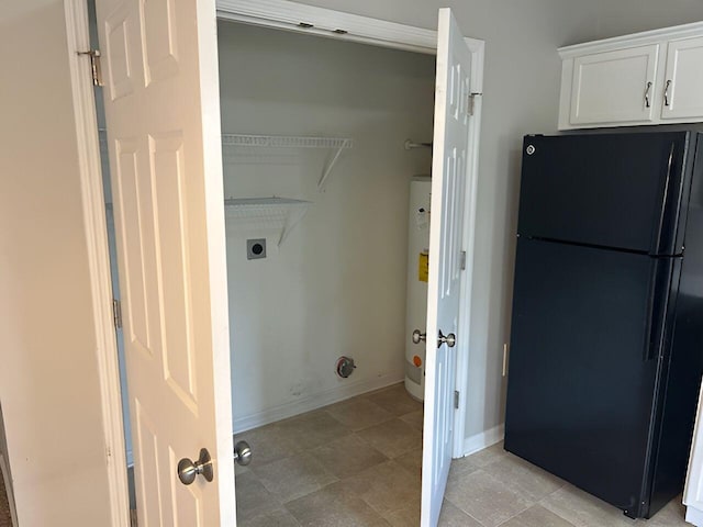1204 Red Stone Dr, Lexington, KY 40509 - clothes washing area featuring water heater, electric dryer hookup, light tile patterned floors, and baseboards