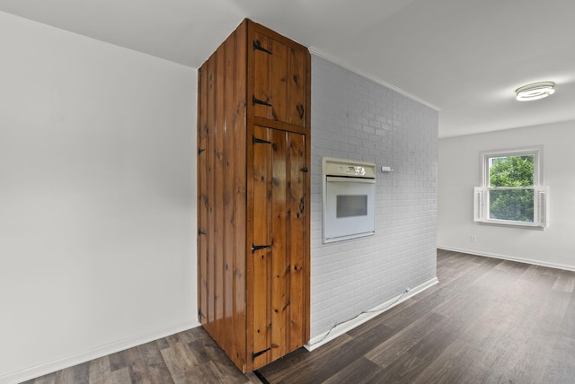 834 Boyd Ave, Danville, KY 40422 - kitchen featuring white oven, dark wood-style flooring, baseboards, and brick wall