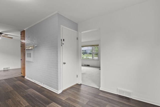 834 Boyd Ave, Danville, KY 40422 - spare room with wood finished floors, a ceiling fan, baseboards, and brick wall