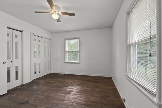 834 Boyd Ave, Danville, KY 40422 - unfurnished bedroom featuring two closets, wood finished floors, baseboards, and a ceiling fan