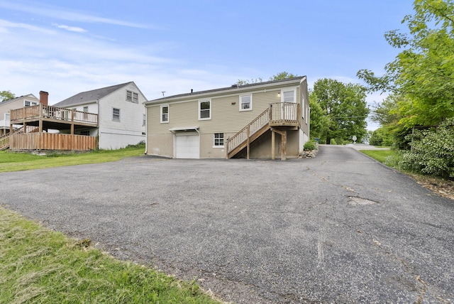834 Boyd Ave, Danville, KY 40422 - back of house with stairs, an attached garage, and asphalt driveway
