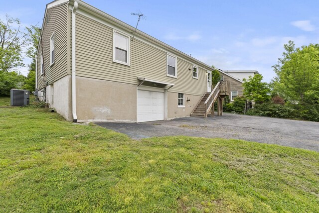 834 Boyd Ave, Danville, KY 40422 - rear view of property featuring cooling unit, stairs, a garage, a lawn, and driveway