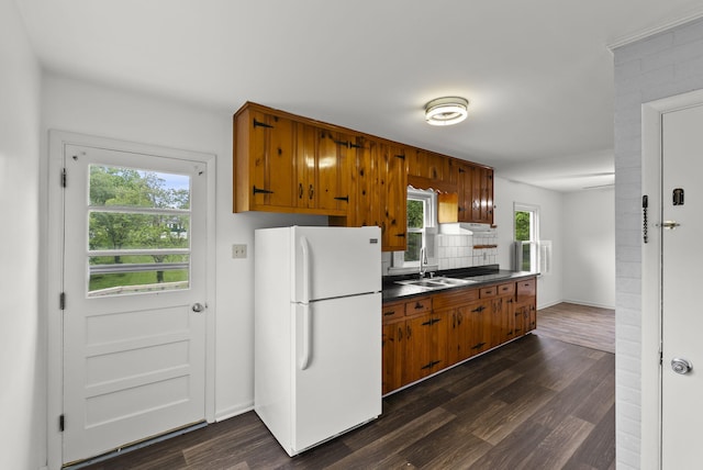 834 Boyd Ave, Danville, KY 40422 - kitchen featuring freestanding refrigerator, dark countertops, a sink, dark wood-style flooring, and brown cabinets