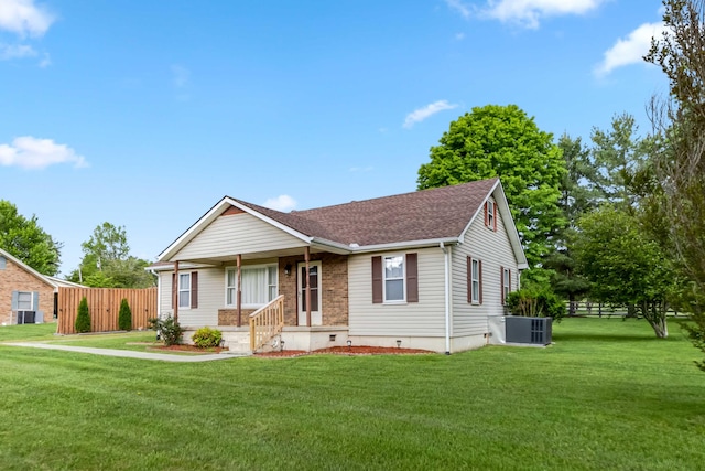 ranch-style house featuring central AC, a shingled roof, and a porch