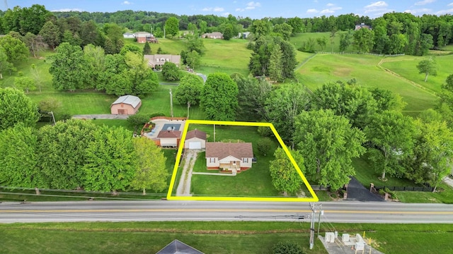 aerial view of property and surrounding area featuring property parcel outlined