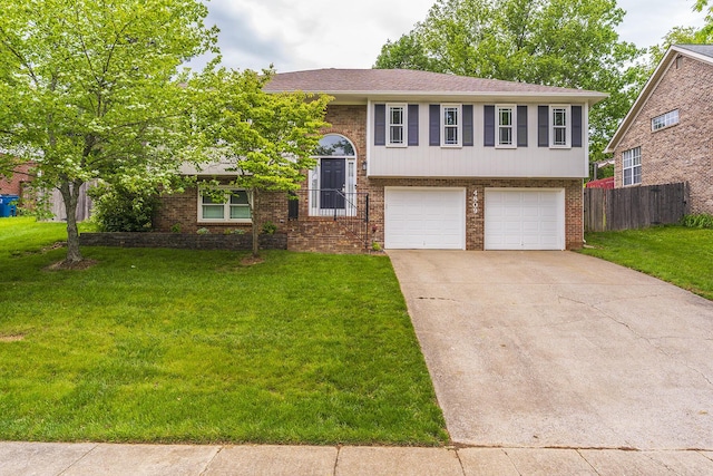 raised ranch with brick siding, an attached garage, concrete driveway, and a shingled roof