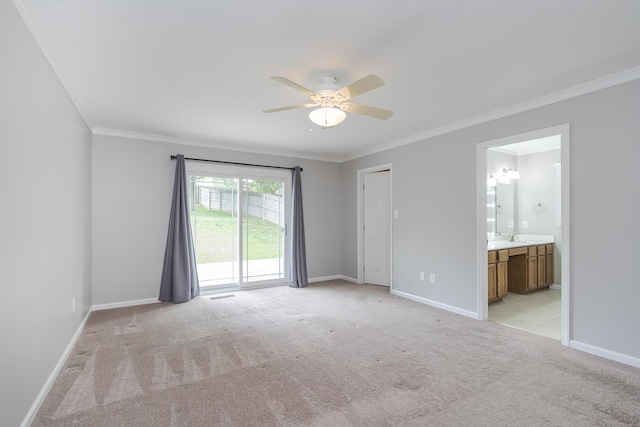 unfurnished bedroom with light carpet, crown molding, baseboards, access to outside, and a sink