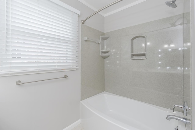 bathroom with washtub / shower combination and baseboards