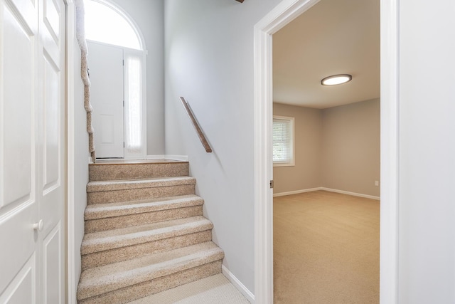 stairway featuring carpet flooring and baseboards