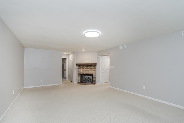 unfurnished living room with baseboards, light colored carpet, and a fireplace