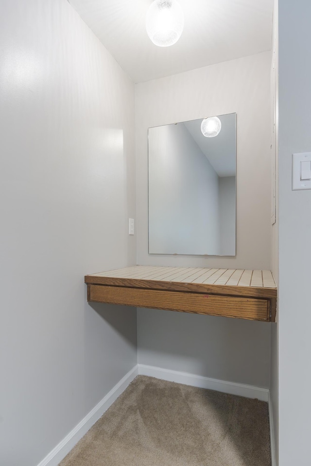 walk in closet featuring carpet flooring
