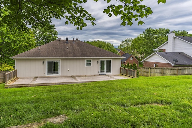 rear view of property featuring a deck and roof with shingles