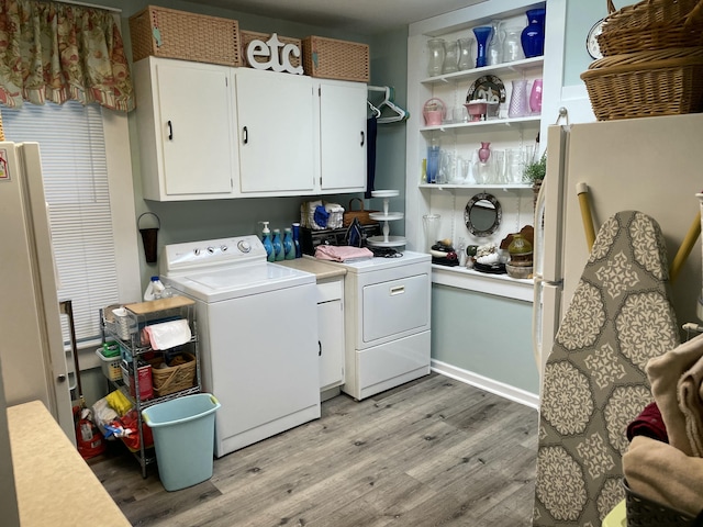 218 W Campbell St, Frankfort, KY 40601 - laundry room featuring light wood-type flooring, washer and clothes dryer, and cabinet space
