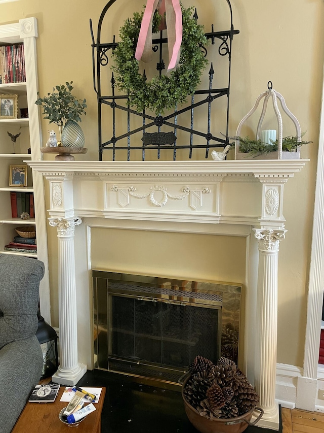 218 W Campbell St, Frankfort, KY 40601 - detailed view of a fireplace with raised hearth, ornate columns, and wood finished floors