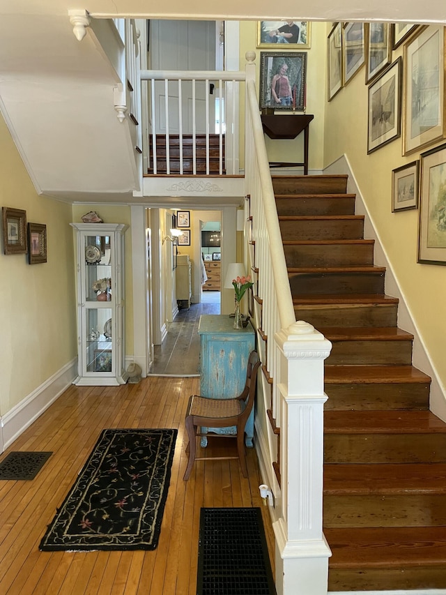 218 W Campbell St, Frankfort, KY 40601 - stairs with hardwood / wood-style flooring, baseboards, and a towering ceiling