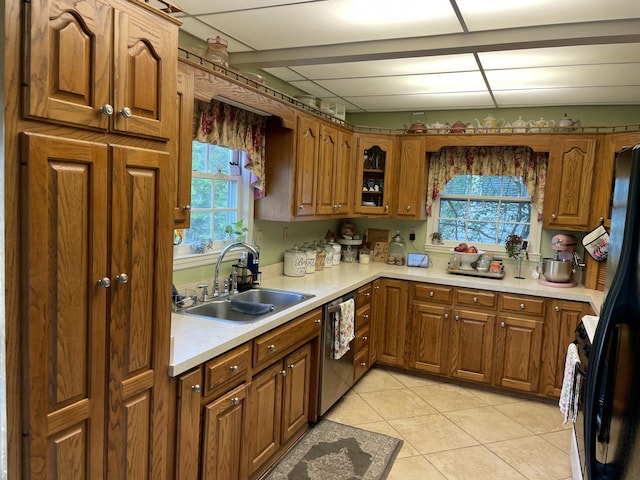 218 W Campbell St, Frankfort, KY 40601 - kitchen featuring a sink, brown cabinets, light countertops, stainless steel dishwasher, and light tile patterned floors