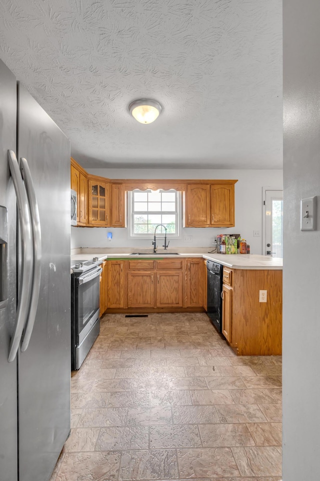 501 Ashley Ct, Berea, KY 40403 - kitchen with stainless steel appliances, a sink, glass insert cabinets, light countertops, and a textured ceiling