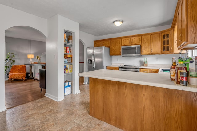501 Ashley Ct, Berea, KY 40403 - kitchen with stainless steel appliances, arched walkways, and light countertops