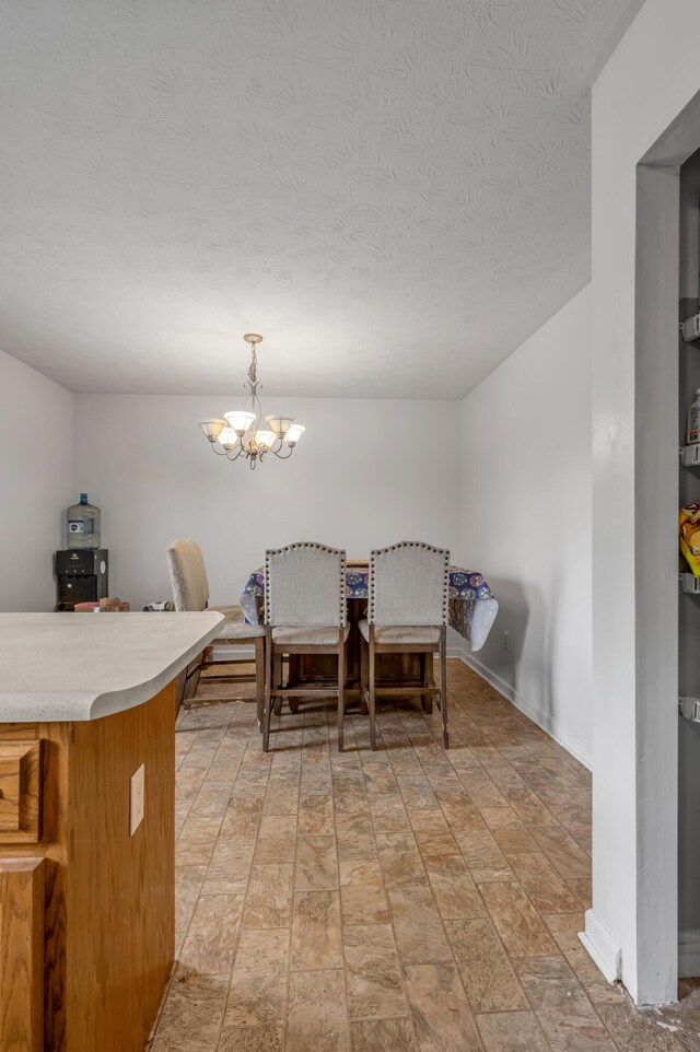 501 Ashley Ct, Berea, KY 40403 - dining room featuring a chandelier, a textured ceiling, baseboards, and light stone finish flooring