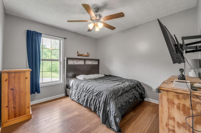 501 Ashley Ct, Berea, KY 40403 - bedroom with baseboards, hardwood / wood-style flooring, ceiling fan, and a textured ceiling