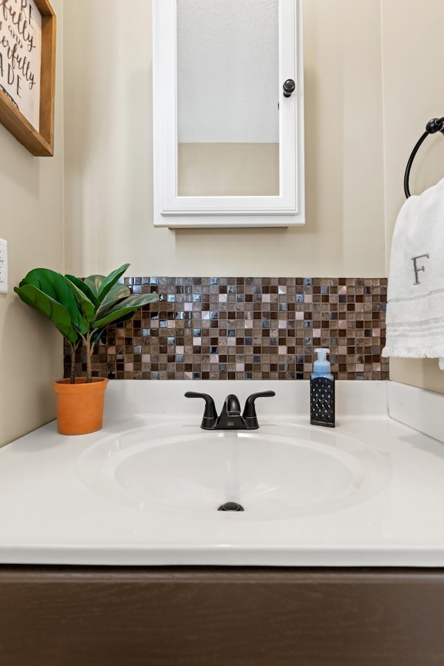 bathroom with vanity and tasteful backsplash