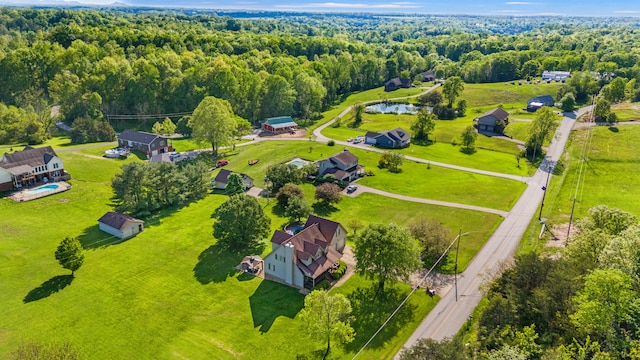 aerial view of property and surrounding area featuring property parcel outlined and a heavily wooded area