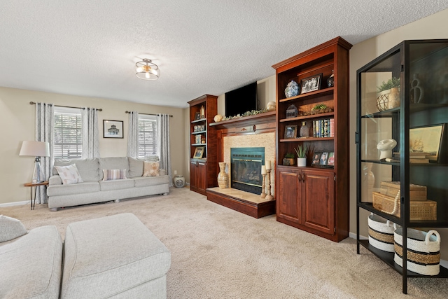 living area featuring light carpet, a large fireplace, a textured ceiling, and baseboards