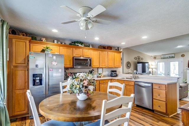 129 General Cleburne Dr, Richmond, KY 40475 - kitchen featuring stainless steel appliances, a peninsula, light wood-type flooring, a ceiling fan, and a sink