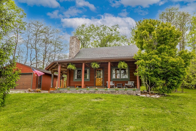 134 Pandora Dr, Harrodsburg, KY 40330 - back of house with an outbuilding, log siding, a lawn, an attached garage, and covered porch