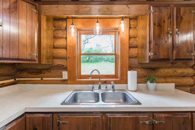 134 Pandora Dr, Harrodsburg, KY 40330 - kitchen featuring log walls, a sink, light countertops, and pendant lighting