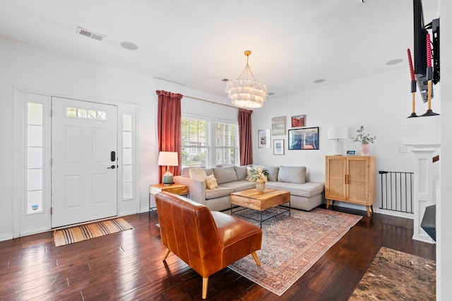 living area with dark wood-style floors and a chandelier