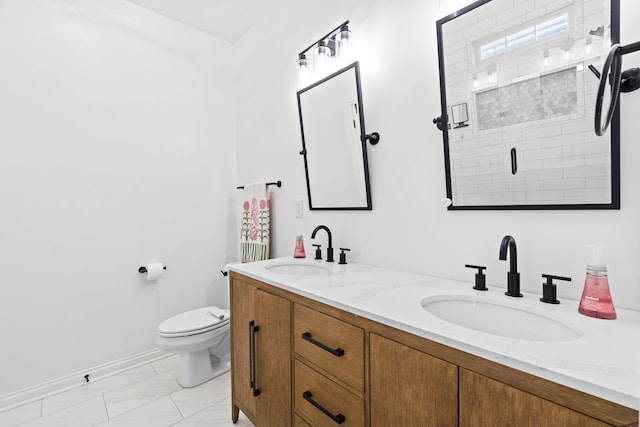 full bathroom with marble finish floors, toilet, a shower stall, and double vanity
