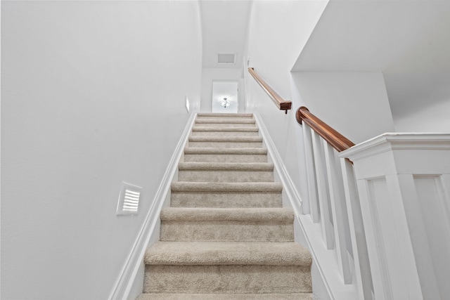 stairway featuring carpet floors