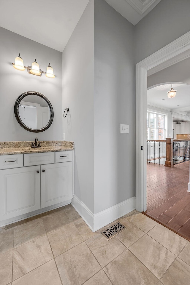 bathroom featuring baseboards and vanity
