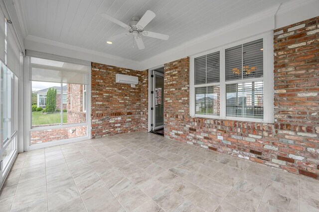 unfurnished sunroom featuring plenty of natural light, a wall unit AC, and a ceiling fan
