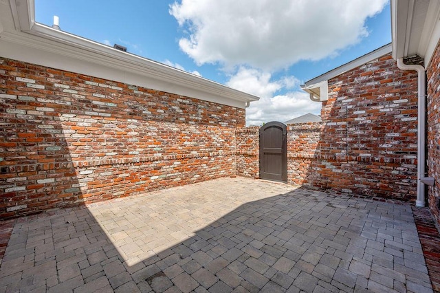 view of patio featuring a gate