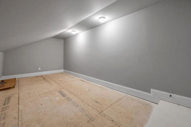 additional living space with vaulted ceiling and baseboards