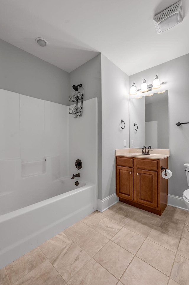 bathroom with toilet, vanity, baseboards, and tile patterned flooring