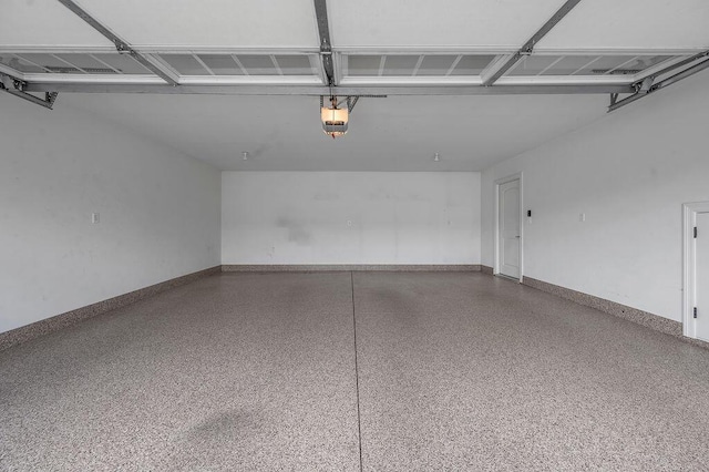 garage with baseboards and a garage door opener