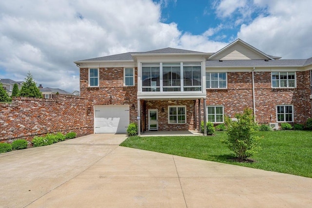 back of property featuring driveway, a garage, a yard, brick siding, and a shingled roof