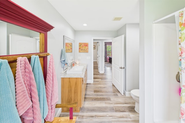 663 John R Jones Rd, London, KY 40741 - bathroom with wood finished floors, vanity, toilet, recessed lighting, and baseboards