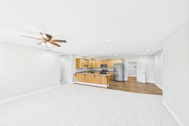 663 John R Jones Rd, London, KY 40741 - unfurnished living room featuring carpet flooring, baseboards, ceiling fan, recessed lighting, and a sink