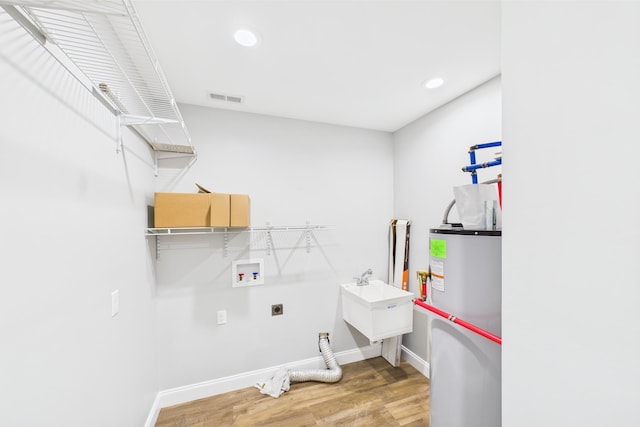 663 John R Jones Rd, London, KY 40741 - laundry room featuring washer hookup, gas water heater, light wood-style flooring, hookup for an electric dryer, and baseboards