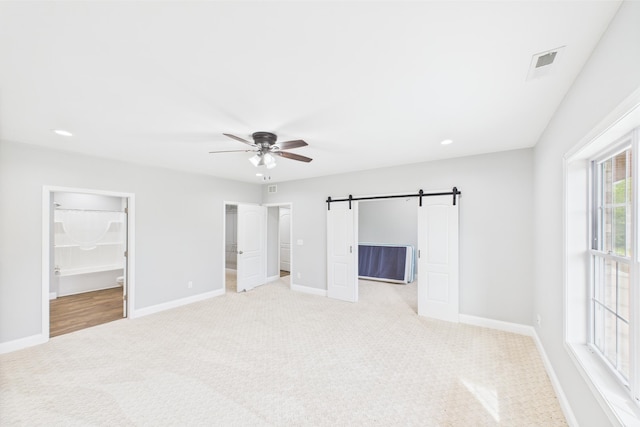 663 John R Jones Rd, London, KY 40741 - unfurnished bedroom with a spacious closet, light colored carpet, a barn door, baseboards, and recessed lighting