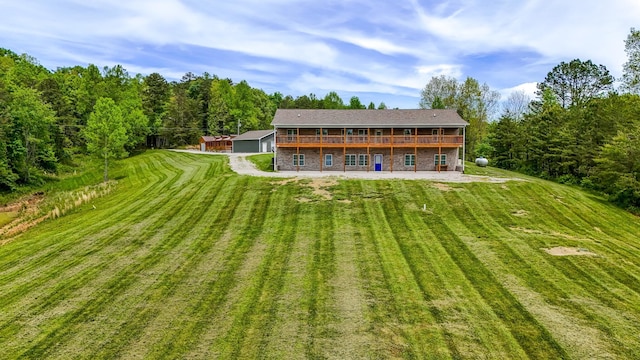 663 John R Jones Rd, London, KY 40741 - rear view of property featuring a yard, a deck, brick siding, and a patio area